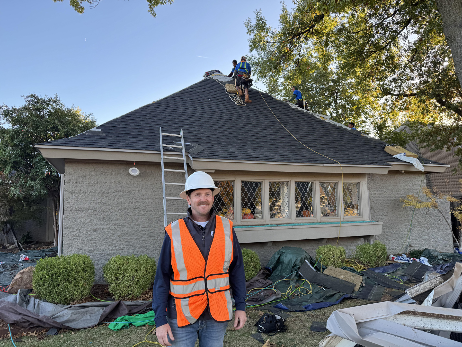 owner smiling at camera during roofing job